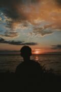 Silhouette of a person against a breathtaking Puerto Vallarta sunset over the ocean.